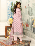 Woman in a pink traditional outfit standing in a decorated room with a painting and decorative elements.