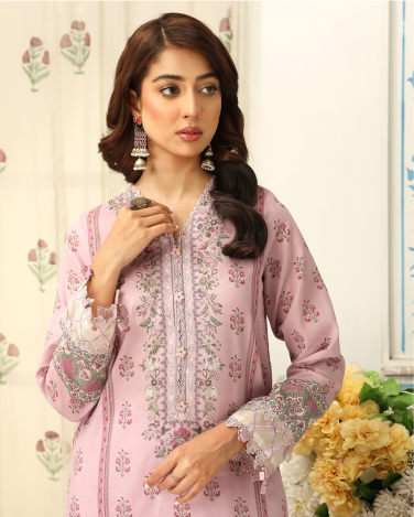Woman wearing a pink embroidered outfit with floral background