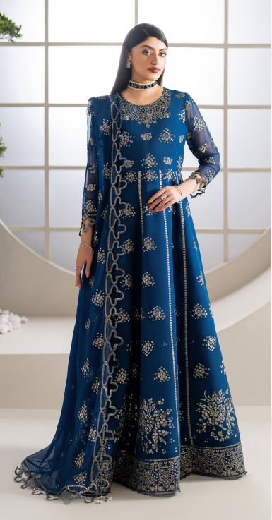 Woman wearing a blue embroidered traditional outfit with a white background