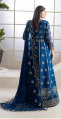 Woman wearing a blue embroidered traditional outfit with a white background