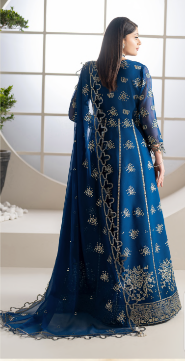 Woman wearing a blue embroidered traditional outfit with a white background