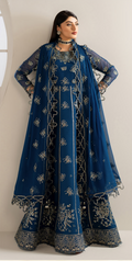 Woman wearing a blue embroidered traditional outfit with a matching dupatta against a white background
