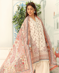 Woman wearing a traditional outfit with a floral shawl in an outdoor setting