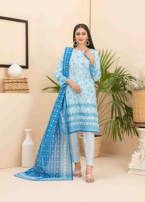 Woman wearing a blue embroidered outfit in a home setting