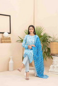 Woman in a blue outfit with a matching dupatta in a decorated indoor setting