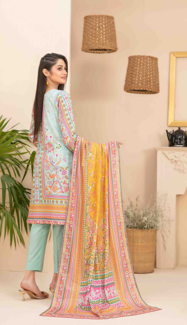 Woman in a light blue outfit with a colorful dupatta in a room with plants and lamps.