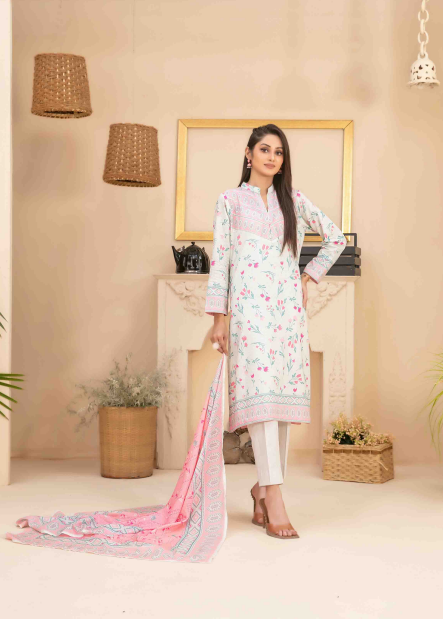 Woman in a light-colored traditional outfit with a floral pattern in a decorated room.