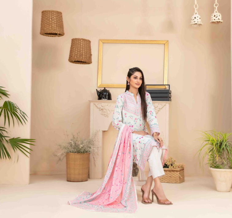 Woman in a floral outfit sitting in a decorated room with plants and a mirror.