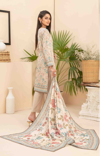 Woman holding a floral dupatta in a home setting with plants and decor.