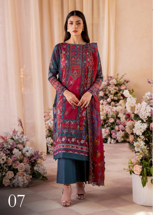 Woman in a colorful traditional outfit standing in front of floral decorations.