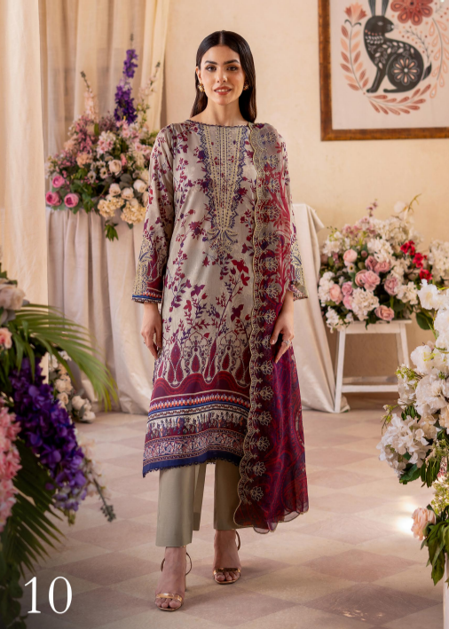 Woman in a floral embroidered outfit standing in a decorated room with flowers and a painting.