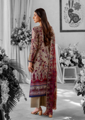 Woman in a floral dress standing in a decorated room with flowers and a rabbit illustration.