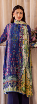 Woman wearing a colorful embroidered dress with a neutral background