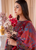 Woman holding a bouquet of flowers wearing a colorful traditional outfit.