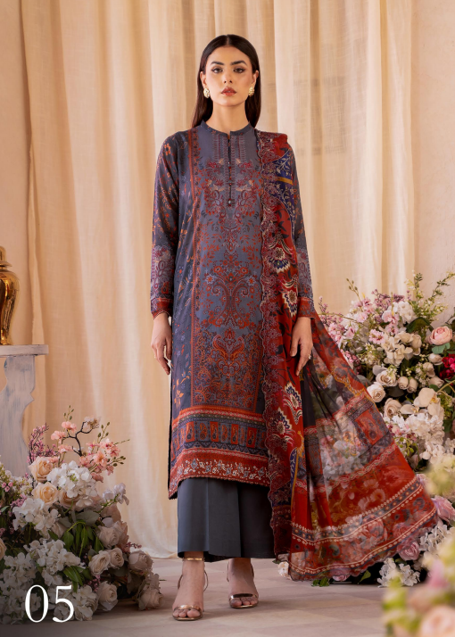 Woman wearing a patterned dress standing in front of floral decorations and a beige curtain.