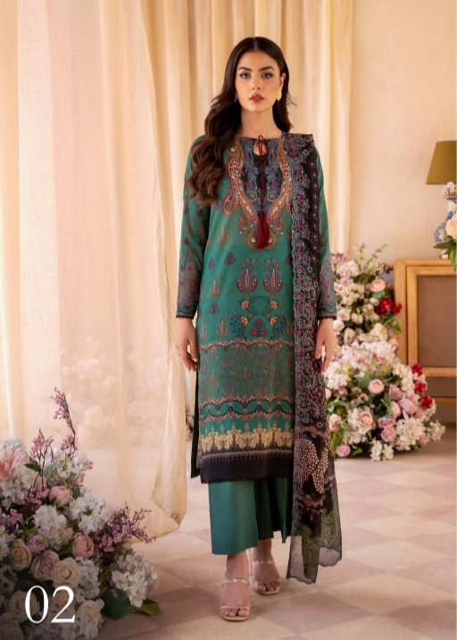 Woman in a green embroidered outfit standing in a decorated room with flowers.