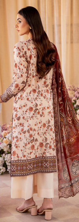 Woman wearing a floral kurta with a matching dupatta in a decorated room.