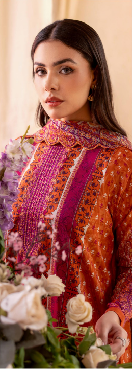 Woman in an orange and pink traditional outfit with floral decorations