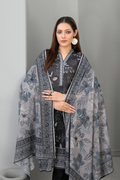 Woman wearing a patterned shawl against a plain background
