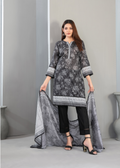 Woman wearing a gray floral dress with black pants and holding a matching dupatta against a gray background