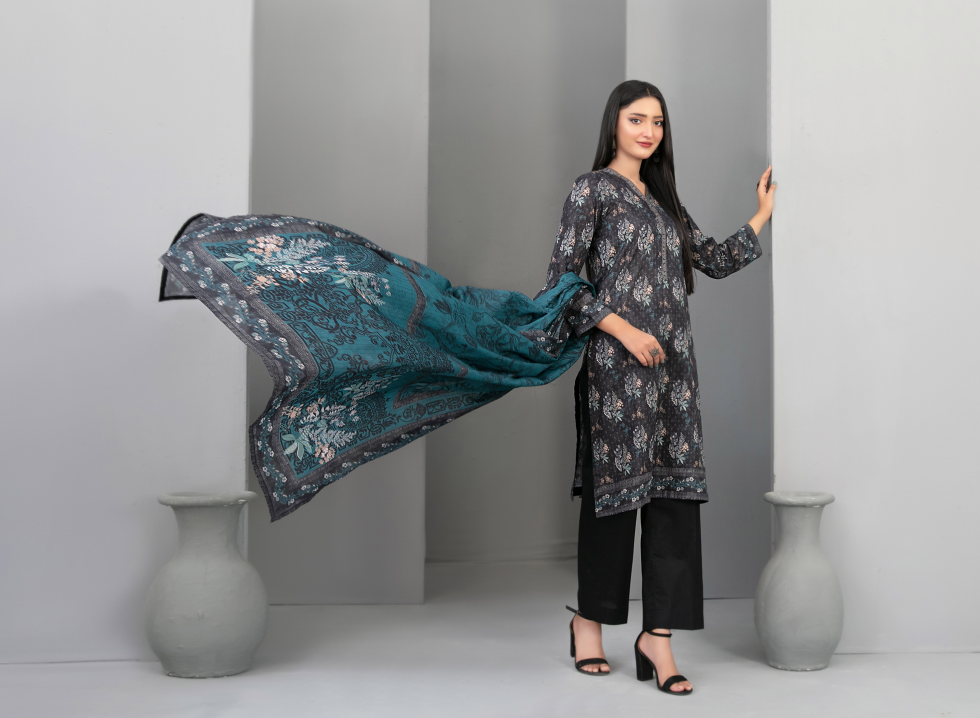 Woman holding a floral scarf in a minimalistic setting with gray vases.