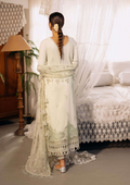 Woman in a white traditional outfit standing in a bedroom with lace curtains and furniture.
