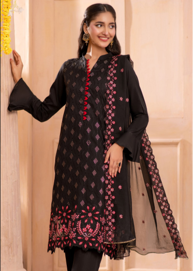 Woman wearing a black and pink embroidered traditional outfit with a sheer dupatta.