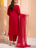 Woman wearing a red traditional outfit with a dupatta in an indoor setting