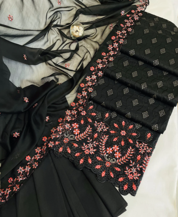 Black embroidered fabric with pink floral patterns on a white background
