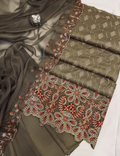 Olive green fabric with intricate red and gold embroidery on a white background