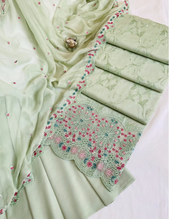 Light green fabric with floral embroidery on a white background