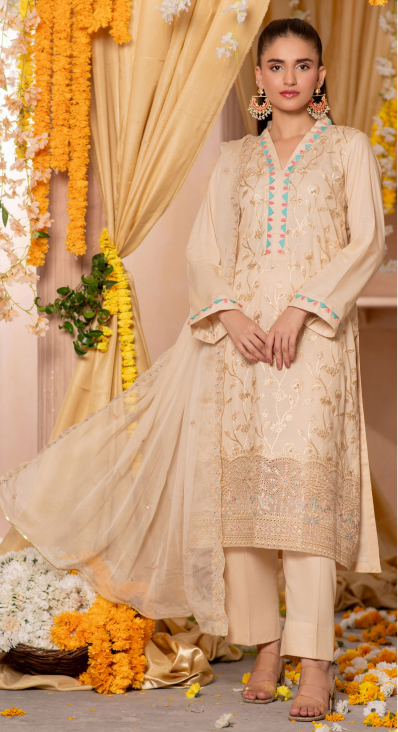 Woman in a beige embroidered traditional outfit with floral decorations in the background