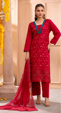 Woman wearing a red traditional outfit with a blue neckline against a neutral background